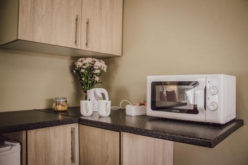 a microwave on a counter in a kitchen at The Daughters Guest House in Bethlehem