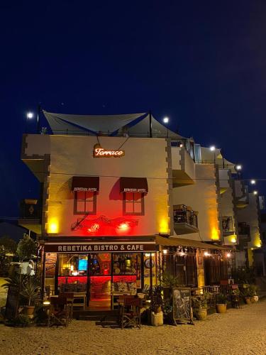 a building with a store with a sign on it at Rebetika Hotel & bistro in Selcuk
