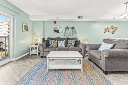 a living room with a couch and a table at Tradewinds Unit 406 in Orange Beach
