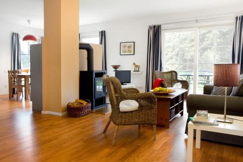 a living room with a couch and a table at Louisenhof Ferienapartments und Wellness in Burg