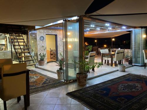 a patio with a dining area with a table and chairs at Rebetika Hotel & bistro in Selcuk