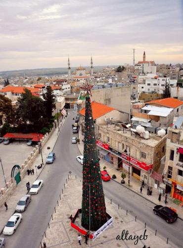 a large christmas tree in the middle of a city at Aitch Boutique Hotel - an LIH Hotel in Madaba