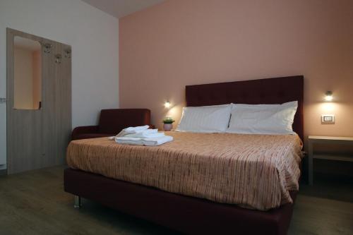 a bedroom with a bed with towels on it at Residence Villa Frio Frio in Ronchi dei Legionari