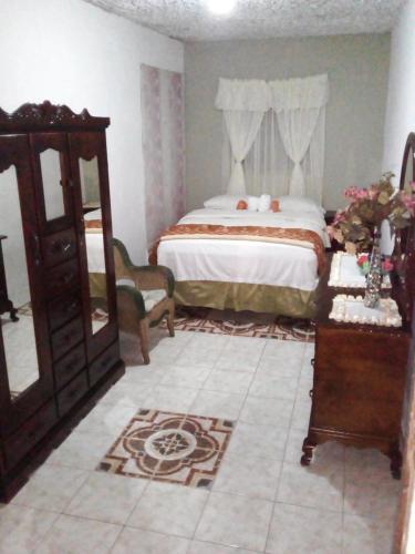 a bedroom with a bed and a dresser in it at Nine Miles Cultural Hangouts and Tours in Stepney