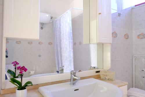 a bathroom with a sink and a mirror and a tub at a casa di Chiara bed and breakfast in Capaccio-Paestum
