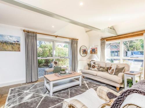 a living room with a couch and a table at Pass the Keys Peaceful and beautiful 1 bedroom barn conversion in Chichester