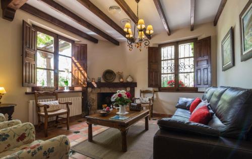 a living room with a couch and a table at Hotel de Montaña Cueva Ahumada in Villaverde de Guadalimar