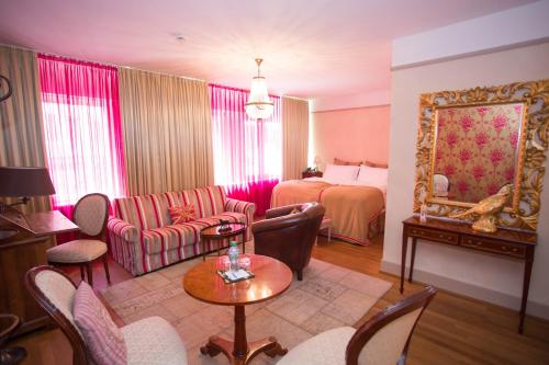 a living room with a couch and a bed at Townhouse Boutique Hotel in Zürich