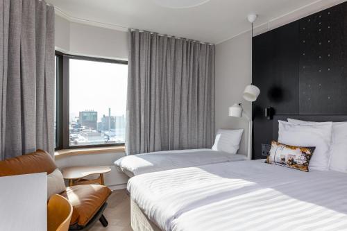 a hotel room with two beds and a window at Original Sokos Hotel Ilves Tampere in Tampere