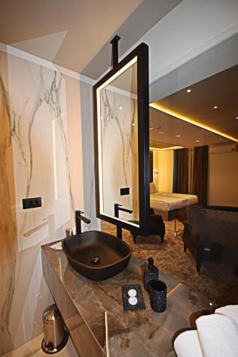 a bathroom with a sink and a mirror at Hotel Boutique Bristol in Sarajevo