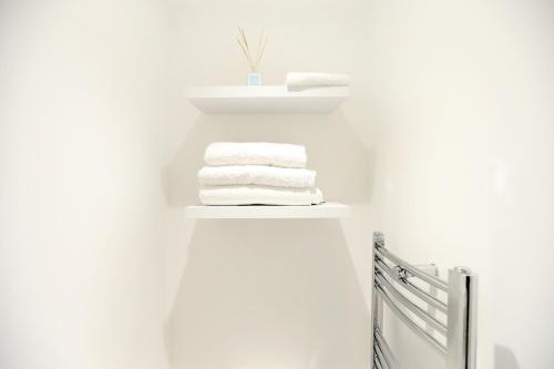 a stack of towels on a shelf in a bathroom at The Willow Bed and Breakfast in Pateley Bridge