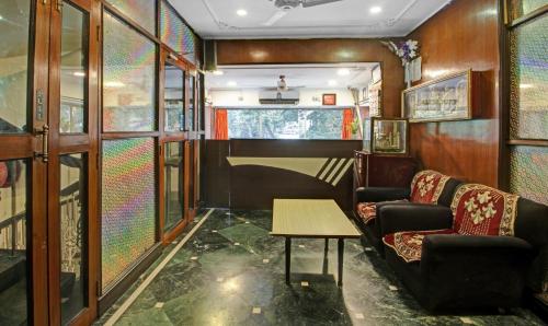 Treebo Trend Mira Inn في كولْكاتا: غرفة بها كنبتين وطاولة في القطار
