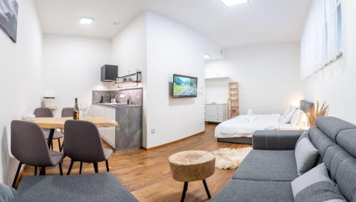 a living room with a couch and a table at Apartmány Resort Vrchlabí in Vrchlabí