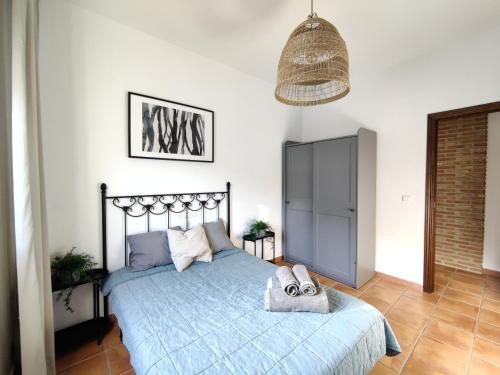 a bedroom with a bed with two shoes on it at Casa Gala - Caminito del Rey in Málaga