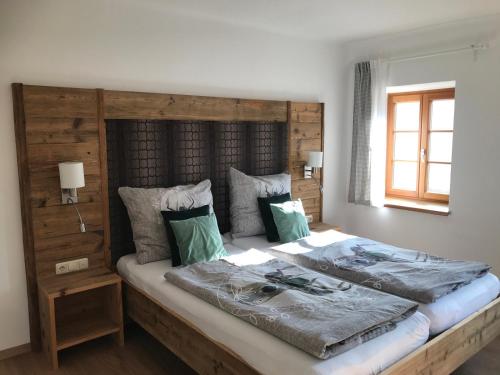 Landhaus Aigner في Allhartsberg: غرفة نوم بسرير كبير مع اللوح الخشبي