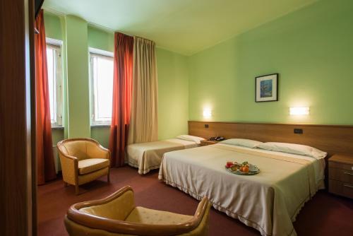 Posteľ alebo postele v izbe v ubytovaní Hotel Lux