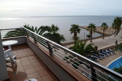a balcony with a view of the beach and the ocean at Miami Mar - Boutique Hotel & Restaurante in Sant Carles de la Ràpita