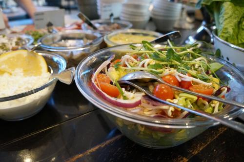 a salad in a glass bowl on a table with other food at Best Western Hotel Corallen in Oskarshamn