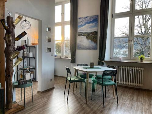 a dining room with a table and chairs and windows at Ferienwohnung Zum Zollkran in Trier
