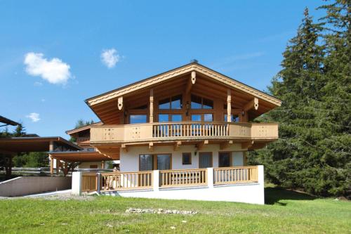 a large wooden house with a large balcony at Chalet in Königsleiten with Wellness & Alps View in Krimml