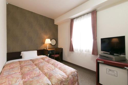Katil atau katil-katil dalam bilik di Hotel Econo Kanazawa Station