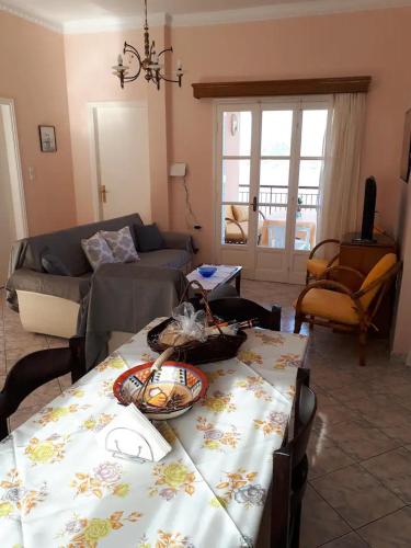 a living room with a table and a couch at Masouri Square Apartment in Masouri