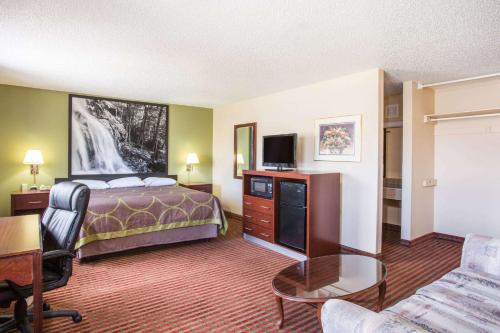 a hotel room with a bed and a desk at Super 8 by Wyndham Harrisonburg in Harrisonburg