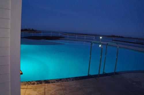 a large blue swimming pool at night at Best Western Hotel Corallen in Oskarshamn