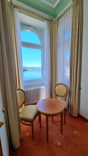 a room with a table and chairs and a window at Seehotel Hubertus in Schluchsee