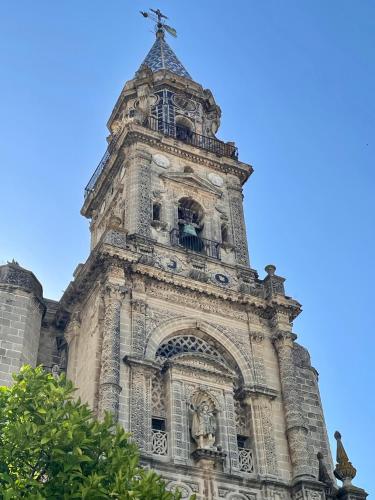 a tall tower with a cross on top of it at Ibis Jerez De La Frontera Cadiz in Jerez de la Frontera