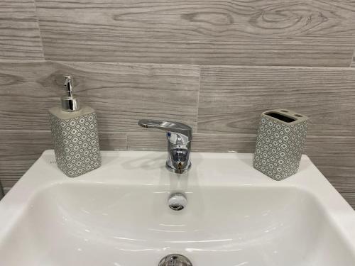 a bathroom sink with a faucet and two soap dispensers at Torino Reale in Turin