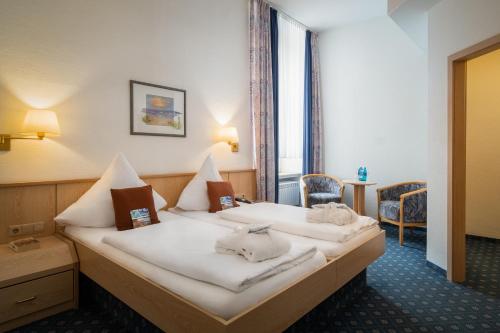 Postel nebo postele na pokoji v ubytování Nordsee Hotel Borkum