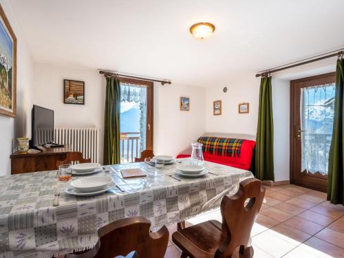 a living room with a table and chairs and a couch at Apartment Grand Sarriod-5 by Interhome in Saint Nicolas