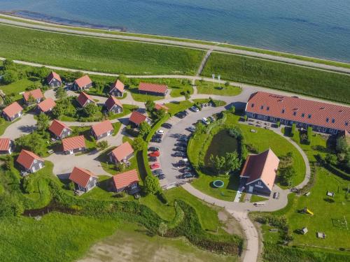 an aerial view of a house near the water at Holiday Home Zeeuwse Cottage Wemeldinge-1 by Interhome in Wemeldinge