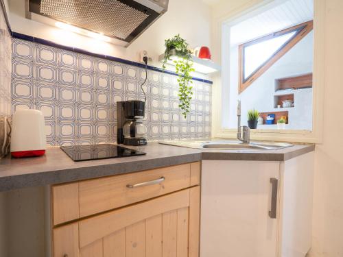 a kitchen with a sink and a counter top at Apartment Coulaoun by Interhome in Biarritz