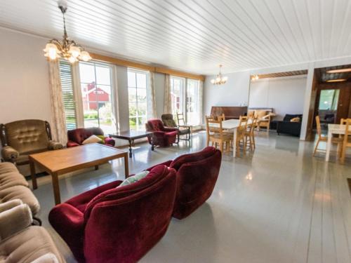 a living room with couches and tables and chairs at Holiday Home Kylämattila by Interhome in Ilola