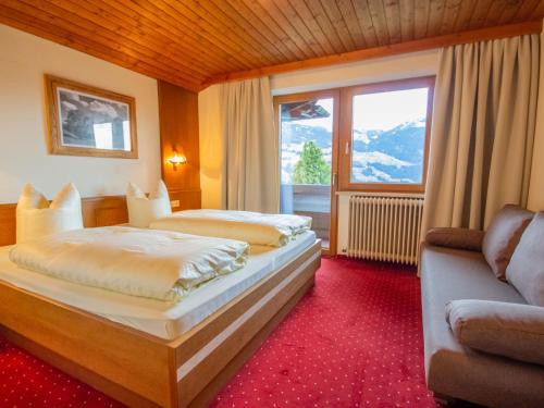 a hotel room with two beds and a window at Apartment Brandegg Top 1 by Interhome in Fügenberg