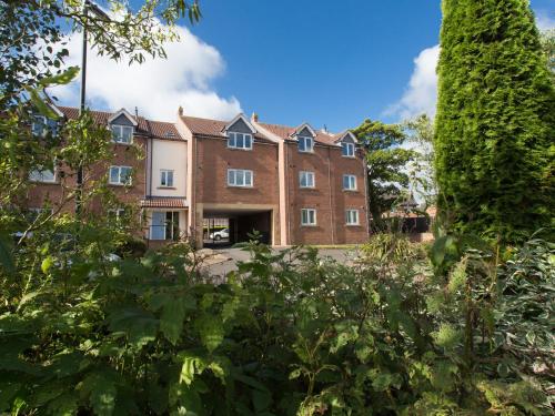 a large brick building with trees in the foreground at 1 Eureka Mews in Chester-le-Street