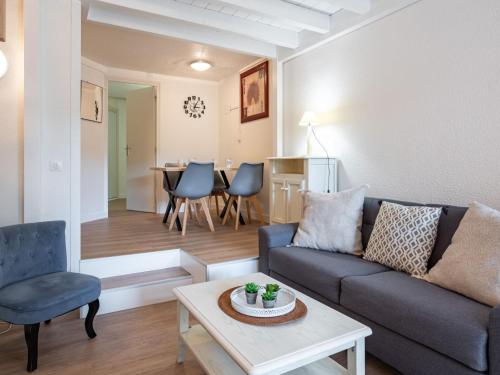 a living room with a couch and a table at Studio du Golf by Interhome in Saint-Cyprien-Plage