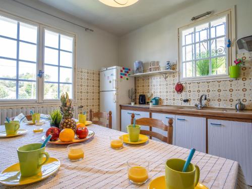 a kitchen with a table with cups and oranges on it at Apartment Eskil Kanta by Interhome in Saint-Jean-de-Luz