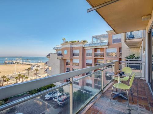 a balcony with a table and chairs and a view of the beach at Apartment Les Tamaris by Interhome in Arcachon