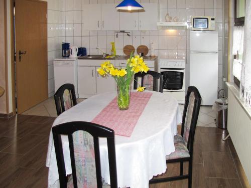 a kitchen with a table with a vase of flowers on it at Holiday Home Siglinde by Interhome in Goldberg