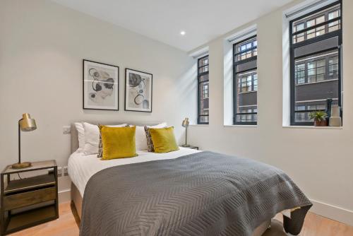 A bed or beds in a room at Whitfield Street Residences by Q Apartments