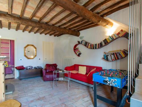 a living room with a red couch and a table at Holiday Home Casa Francesca by Interhome in Rosia