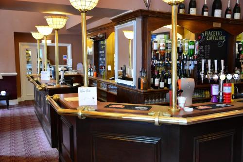 a bar with a lot of bottles of alcohol at The Ennerdale Country House Hotel ‘A Bespoke Hotel’ in Cleator