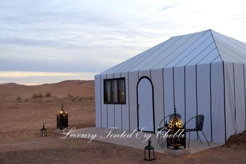 a blue and white tent in the desert at Luxury Tented Erg Chebbi in Merzouga