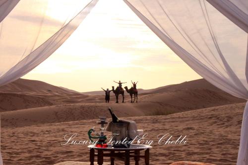 a group of people standing in the desert at Luxury Tented Erg Chebbi in Merzouga