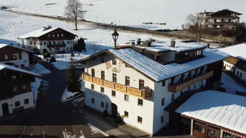 an aerial view of a building in the snow at Ferienwohnungen Kirchenwirt in Thiersee