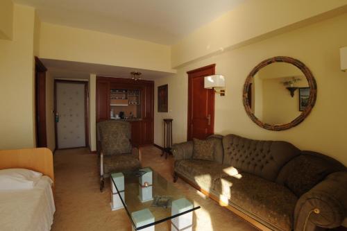 a living room with a couch and a table at Palmariva Beach Hotel in Eretria