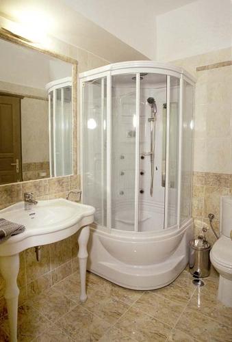 a bathroom with a shower and a sink at Palmariva Beach Hotel in Eretria